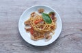 spicy stir fried spaghetti clams with pepper and basil leaf on plate