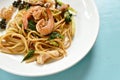 Spicy stir fried spaghetti seafood with pepper and basil leaf on plate Royalty Free Stock Photo