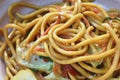 Spicy stir fried vegetarian yakisoba Japanese noodles with cabbage and basil leaf on bowl