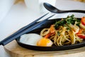 Spicy stir spaghetti with fried eggs on the table, Asia style food Royalty Free Stock Photo