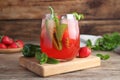 Spicy strawberry cocktail with jalapeno and mint on wooden table