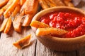 Spicy sweet potato fries with herbs and ketchup macro on the tab Royalty Free Stock Photo
