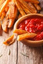 Spicy sweet potato fries with herbs and ketchup macro on the tab Royalty Free Stock Photo