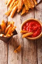 Spicy sweet potato fries with rosemary and herbs and ketchup close-up. Vertical Royalty Free Stock Photo