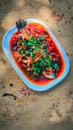 Spicy sweet sour fried sea bass or Siakap Tiga Rasa served with special cooked sauce Royalty Free Stock Photo