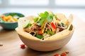 spicy taco salad in a tortilla bowl with cheese Royalty Free Stock Photo