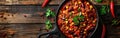 Spicy Texas Hot Chilli Con Carne in Square Pan on Wooden Table with Chilli Peppers as Decorative Background for Food Photography