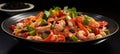 Spicy thai seafood salad on black plate, isolated pastel background, ample text space Royalty Free Stock Photo