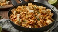 Spicy Tofu Pad Thai in a Black Pan on Wooden Table Royalty Free Stock Photo