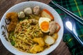 Spicy tom yam noodle soup with boiled egg and grilled red pork. Royalty Free Stock Photo