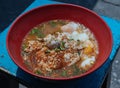 Spicy tom yum egg noodles soup with shrimp dumplings and Medium-boiled eggs, pork slices and pork meatballs Royalty Free Stock Photo