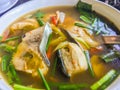 Spicy tom yum fish with thai herb ingredients. Hot spicy and sour Tom Yum fish and seafood soup with herbs, Thai local food Royalty Free Stock Photo