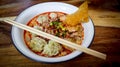 Spicy Tom Yum pork wonton soup with minced pork and fish ball in white bowl Royalty Free Stock Photo