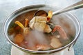 Spicy tom yum soup seafood in hot pot with smoke, Thailand traditional food