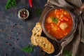 Spicy tomato soup with meatballs, pasta and vegetables. Healthy dinner.