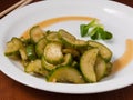 Spicy vegetable appetizer - Korean cucumbers on a white plate Royalty Free Stock Photo