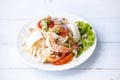 Spicy Vermicelli Seafood Salad with vegetable ingredient on wood white background, Thai food Street food Concept.Top View Royalty Free Stock Photo