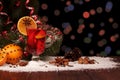 Spicy warming drink, fruits, nuts and spices on dark background