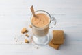 Spicy warming tea with milk in a glass cup and gingerbread cookie