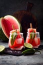 Spicy watermelon popsicle margarita cocktail with jalapeno and lime. Mexican alcoholic drink for Cinco de mayo party.