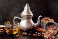 Spicy winter tea in a silver teapot and cup