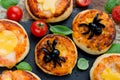 Spider pizza on Halloween. Homemade mini pizza decorated with olives in the form of a spider for kids treats