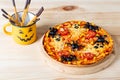 Pizza with spiders and ghosts for halloween on the table, food for halloween