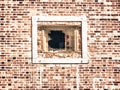 Spider web on a metallic broken and aged window of a brick building Royalty Free Stock Photo