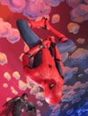 Spiderman Hanging Upside Down with Captain America in the Background Royalty Free Stock Photo