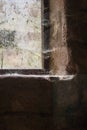 Spiderwebs on an Old Stone Framed Window