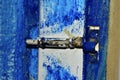 Spiegele iron latch on a blue painted door Royalty Free Stock Photo