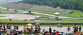 Spielberg Austrian Moto GP Moto 2 class. Blurred Crowd with a moto 2 bike and Red Bull Ring GP track in background. Royalty Free Stock Photo