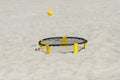 Spike ball game with yellow ball on sand. Summer game concept