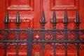 Spike wrought iron fence in front of red door at boarding school, NY Royalty Free Stock Photo