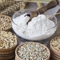 Spikelets of wheat, grains of wheat and oats in boxes, flour in boxing close-up Royalty Free Stock Photo