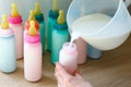 Spill milk into bottles with colored lids and nipples