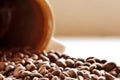 Spilled coffee beans from brown ceramic mug Royalty Free Stock Photo