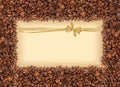 Spilled coffee beans frame over burlap textile with greeting Royalty Free Stock Photo