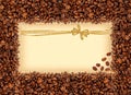 Spilled coffee beans frame over burlap textile with greeting Royalty Free Stock Photo