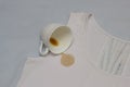 Spilled coffee cup on white shirt, coffee stain on clothes, close-up, cup, stain remover Royalty Free Stock Photo