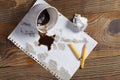 Spilled coffee, paper and pencil
