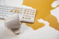 Spilled cup of black coffee on computer keyboard on white table. Royalty Free Stock Photo