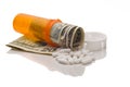 Spilled expensive pills from medication bottle Royalty Free Stock Photo