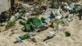 Spilled garbage on beach of big city. Empty used dirty plastic bottles. Dirty sea sandy shore Black Sea. Environmental pollution. Royalty Free Stock Photo