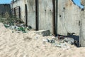 Spilled garbage on beach of big city. Empty used dirty plastic bottles. Dirty sea sandy shore Black Sea. Environmental pollution. Royalty Free Stock Photo