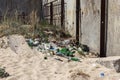 Spilled garbage on beach of big city. Empty used dirty plastic bottles. Dirty sea sandy shore Black Sea. Environmental pollution. Royalty Free Stock Photo