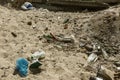 Spilled garbage on beach of big city. Empty used dirty plastic bottles. Dirty sea sandy shore Black Sea. Environmental pollution. Royalty Free Stock Photo