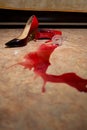 A spilled glass of wine and women`s shoes on the floor