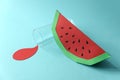 Spilled juice and paper watermelon on blue background. Copy space. Creative or art food concept Royalty Free Stock Photo