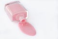 Spilled nail polish in a glass bottle on a white background, pink enamel for french manicure. Cosmetic product. Empty place for Royalty Free Stock Photo